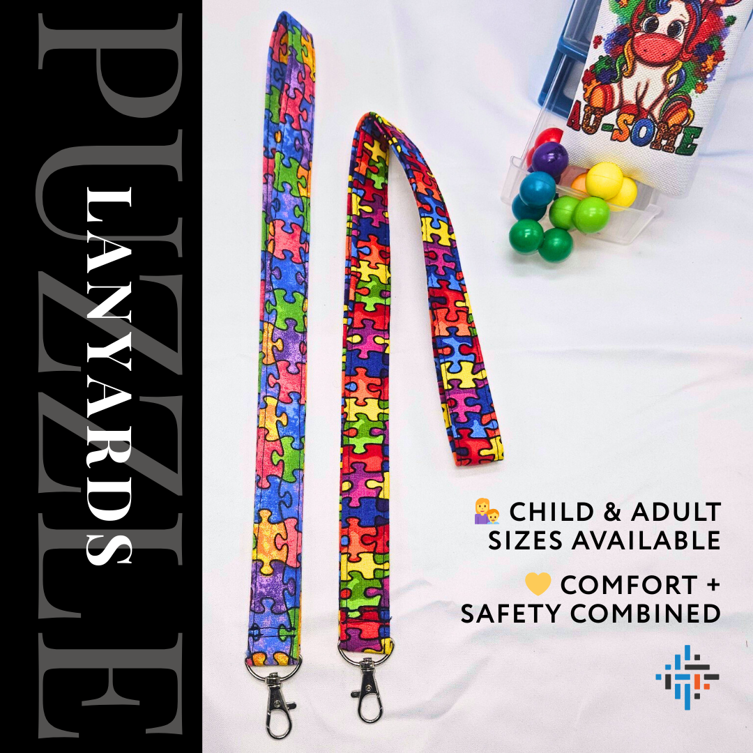 Two handmade autism puzzle piece fabric lanyards in child and adult sizes with swivel hooks – comfort and safety combined.