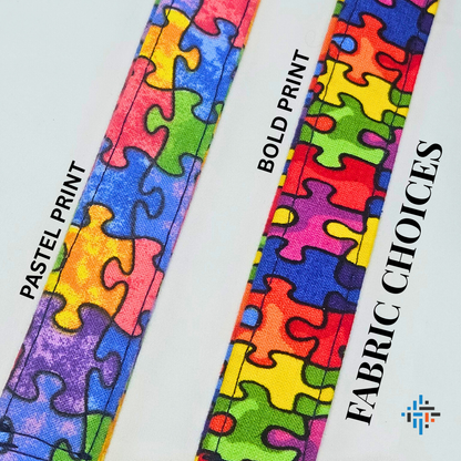 Close-up of handmade puzzle piece lanyards showing fabric choices – pastel print and bold print options for children and adults.